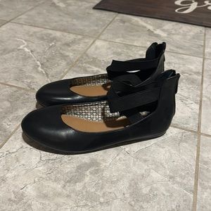 Black leather flat strapped shoes